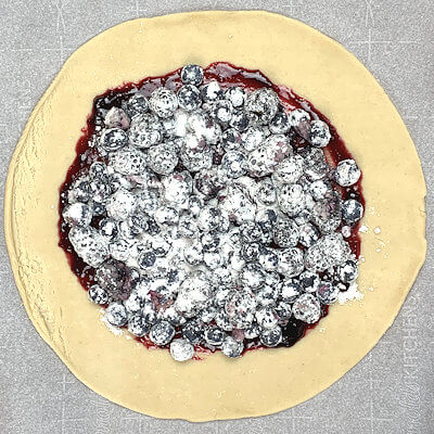 Step 4 - Spread the mixture of berries and sugar on top of the jelly.