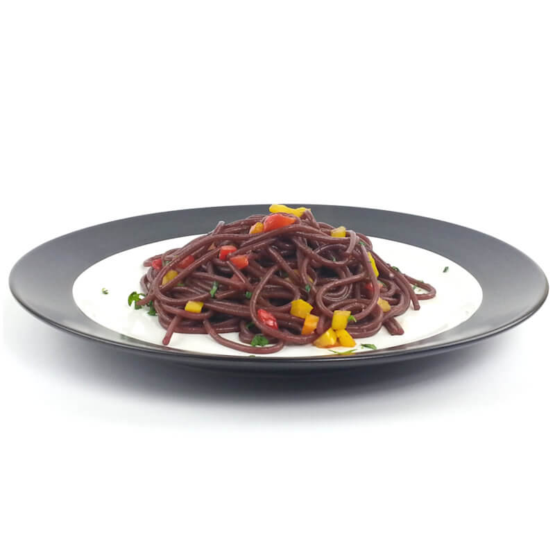 White plate with black border serving drunken spaghetti with pepper confetti