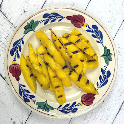 Step 3 - Heat a tablespoon of oil in a grill pan on high heat and grill the mango wedges on both sides. You will end up with beautiful grill marks.