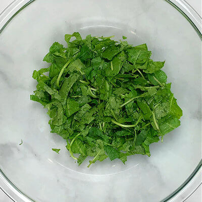 Step 3 - Chop the baby kale a little bit and transfer into a bowl. There is no need to massage it; it's delicate enough to eat without it.