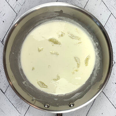 Step 4 - Warm a skillet over medium heat and add the cream and lemon segments and bring to a summer and allow the cream to thicken, approx. 5 minutes.