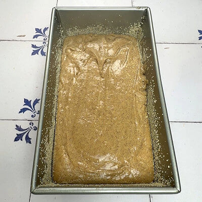 Step 5- Grease a 9 x 5-inch cake form and dust with breadcrumbs. Transfer the dough into the cake pan and level the top. Bake in a preheated oven of 325 degrees F. for about 50 minutes or until a toothpick comes out clean.