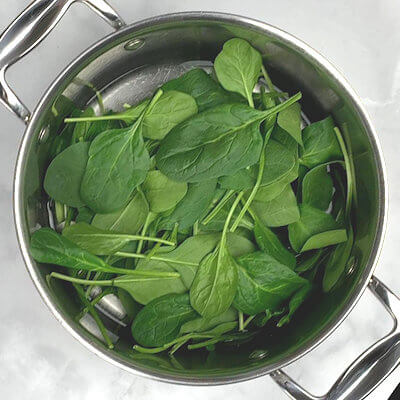 Step 1 - Wash the spinach. Cook the spinach until it is completely wilted and has turned bright green. Drain spinach in colander, chop it fine and squeeze out as much liquid as you can.