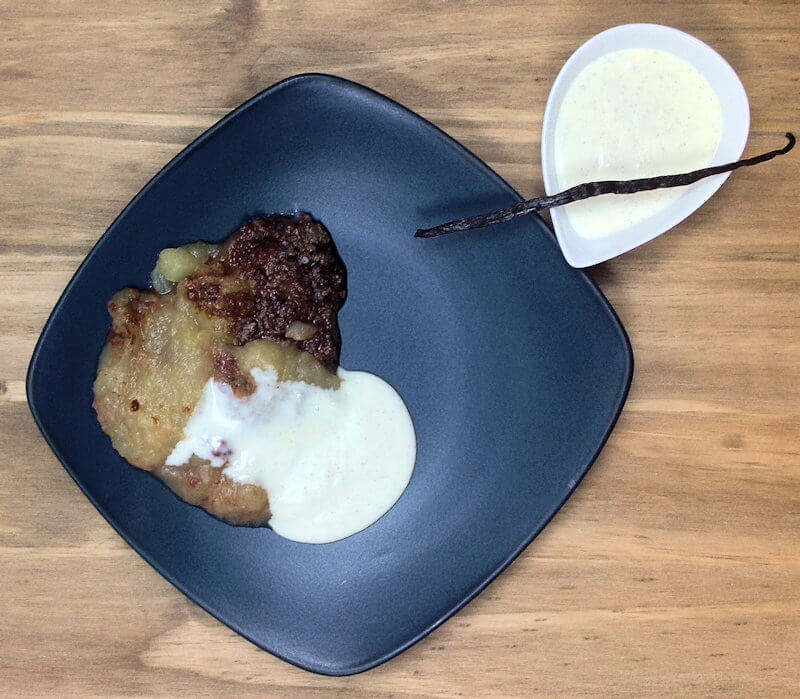 Plated baked apple dessert with cold vanilla sauce