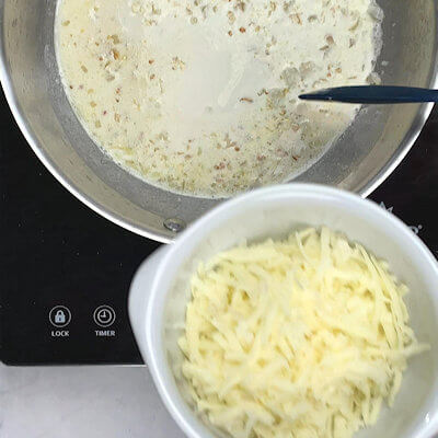 Step 2 - Add cream to the onions and stir. Then add low-moisture mozzarella and stir again until melted.If you're using 'normal' mozzarella you may experience a lot of stringiness that looks like one big lump. To 'dissolve' the lumps, add a little bit of lemon juice. If that does not work at a little bit of flour.