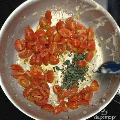 Step 6 - Add the cherry tomatoes to the same skillet and cook on high until the tomato skins start to burst. Don't cook the tomatoes to mush. Add the chopped sage at the last moment and divide tomato mixture over bowls, just before serving.