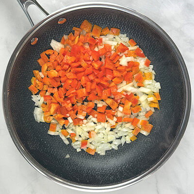 Step 2 - Heat the olive oil in a skillet and cook the onion and bell pepper until slightly softened. This is called sweat the onion and bell pepper.