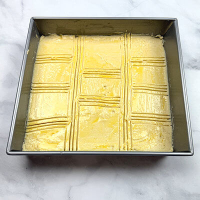 Step 3 - Beat 1/2 egg and brush the top of the cake. Use a knife or fork to carve or score the top of the cake. 