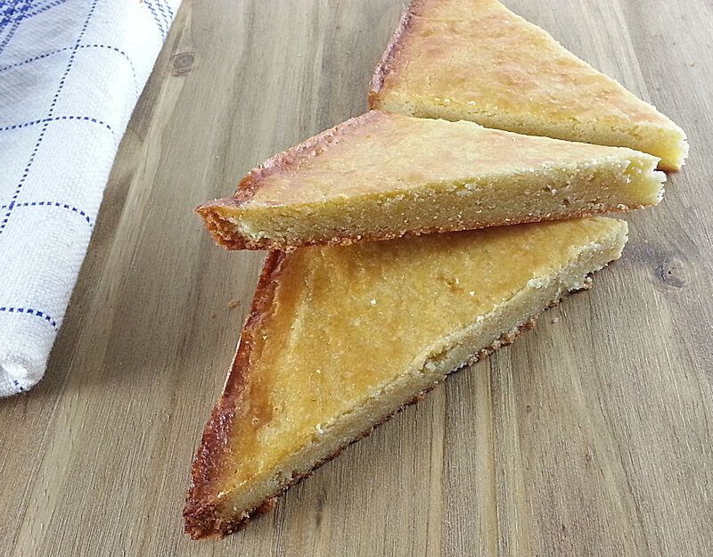 Cut wedges of boterkoek or Dutch butter cake