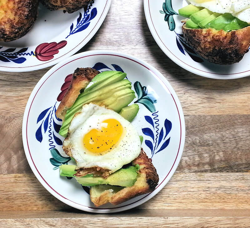 Zoomed in on cheddar popover with Avocado and fried egg