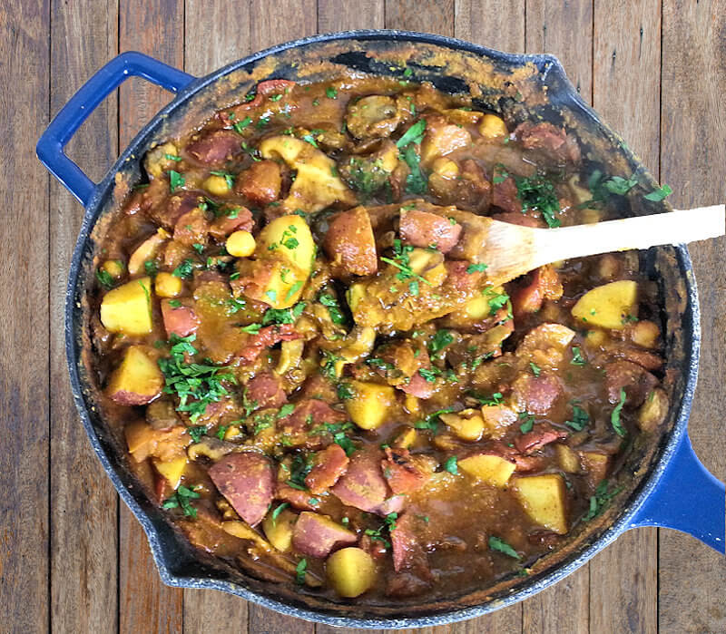 Top down image of Chickpea, Potato and Tomato Curry in skillet