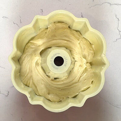 Step 4 - Grease a small bundt cake and fill it with half of the cake batter.