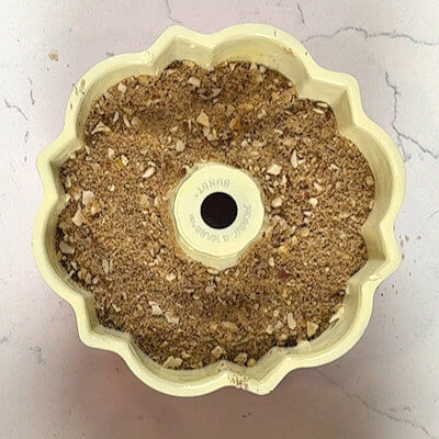 Step 5 - Grind the mixed nuts fine and divide them over the cake batter. Cover the ground nuts with the remaining cake batter. Place the bundt pan in the oven (300°F) and bake for about 30 minutes.