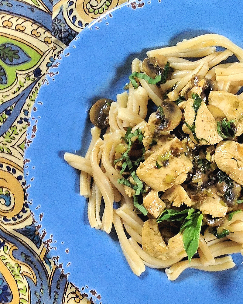 Close-up of pasta with chicken, mushrooms & walnuts