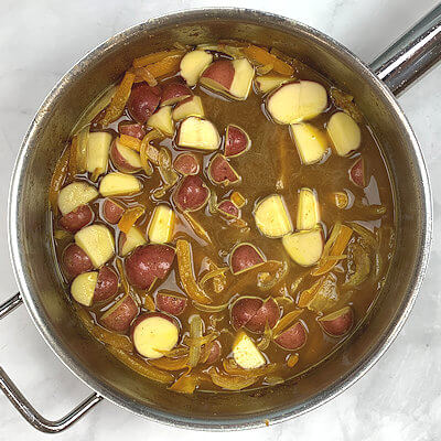 Step 4 - Add chicken stock and potatoes. Bring to a simmer and cook for 7-8 minutes