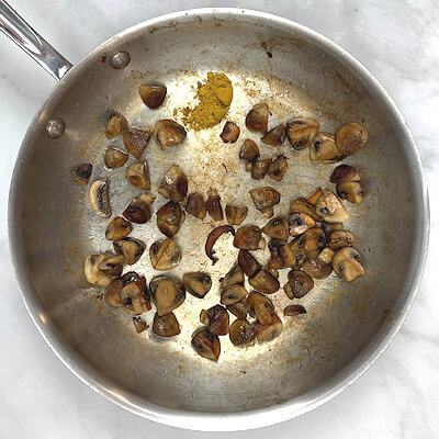 Step 5 - Heat butter in another skillet and add mushrooms, cook them until moisture evaporates. Add 1 teaspoon of curry powder.
