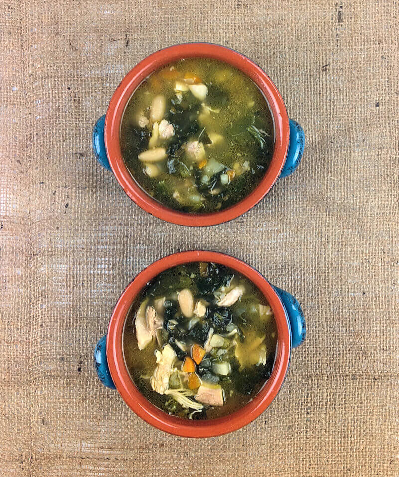 Two bowls of Chicken Soup with Potatoes & White Beans