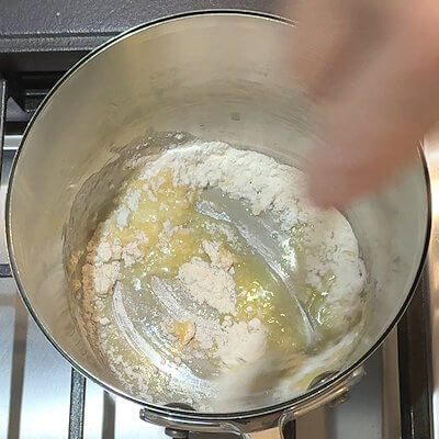 Step 1 - Cook the pasta according to the direction on the packaging. Start making the cheese sauce by creating a roux. Melt butter in a saucepan and add an equal amount of all-purpose flour. Mix and allow to cook on low heat for a few minutes, so the flour is no longer raw.