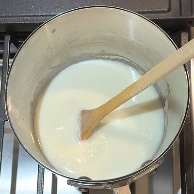 Step 2 - Add the milk to the roux and stir until you have a smooth sauce.