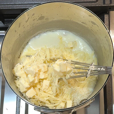 Step 3 - Add all three cheeses to the sauce and allow to melt. You may want to add some pasta water if the sauce is too thick.