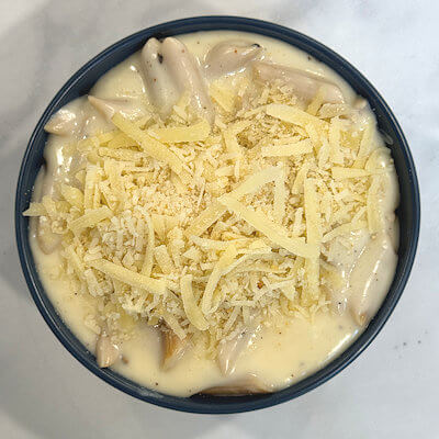 Step 6 - Divide the pasta and sauce over two bowls and sprinkle with some extra Gruyere cheese.