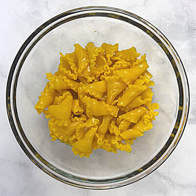 Step 1 - Bring water, salt and turmeric to a boil. Add the pasta cook according the the directions on the packaging. Drain and cool.At the end of the cooking time, the pasta will be beautifully yellow.