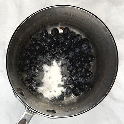 Step 1 - Transfer washed blueberries to a saucepan, add lemon juice, sugar and salt and bring it to a boil. Allow it to simmer until the blueberries become soft, approx. 7-8 minutes. 