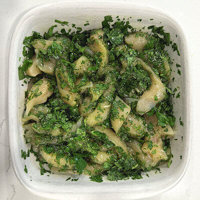 Step 1 - Marinate the chicken; it is not a traditional marinade, but it does help the chicken to soak up some of the flavors. The marinade consists of olive oil, chopped cilantro and salt and pepper. Marinate for a couple of hours.