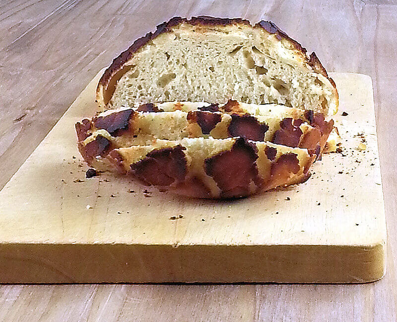 Tiger roll, cut in slices on a wooden plank