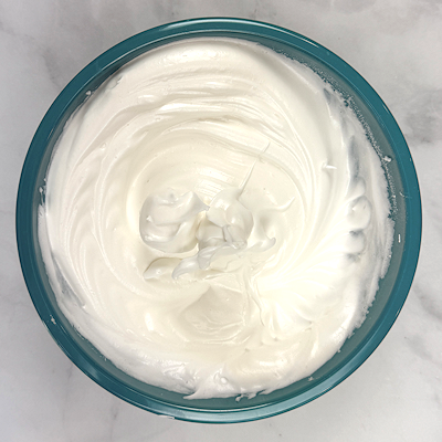 Step 2 - In a separate bowl, beat the egg whites until foamy. Add the cream of tartar and beat until you have soft peaks. Slowly add the sugar to the mixture and beat until you have glossy white peaks. Add the vanilla extract and beat one more time.