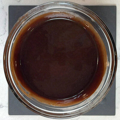 Step 5 - In a microwave-safe bowl, heat the heavy cream to a simmer. Add the dark chocolate and cover the bowl with plastic wrap. After 5 minutes, give the chocolate a stir until it’s completely melted into the cream. Allow it to cool until it reaches a consistency that allows you to pipe it. This can take about 4 hours at room temperature, or you can speed it up in the fridge.