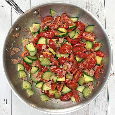 Step 2 - Heat oil in a pan and cook the ham, just a little bit. Add the vegetables and warm them rather than cook them. You want the veggies to stay crunchy.