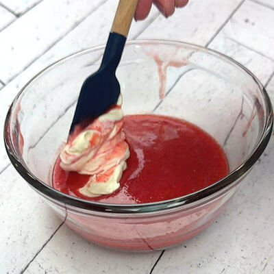 Step 2 - Pour the strawberry puree through a sieve to get rid of the little seeds. Add the creme fraiche and mix well.