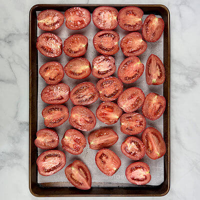 Step 1 - Wash, dry and cut the tomatoes in half. Place them on a baking sheet, lined with parchment paper, cut side up. Season with salt & pepper and drizzle with olive oil.