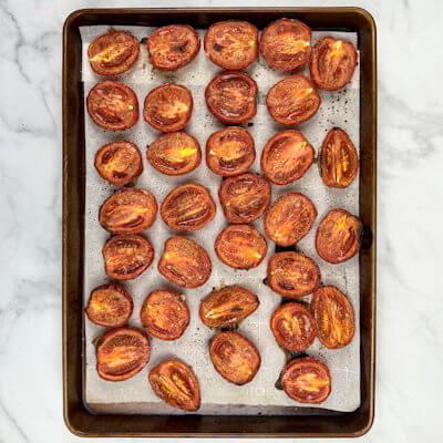Step 2 - Roast the tomatoes in an oven of 400 degrees F for 1-1.5 hours. You will see that the tomatoes begin to wrinkle, but there is still enough moisture left. You don't want to dry them entirely.