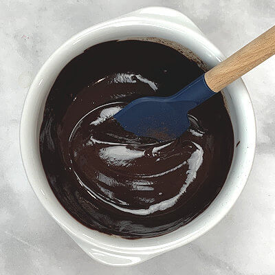 Step 1 - Cut the chocolate in small pieces, add a little bit of warm water and melt it.