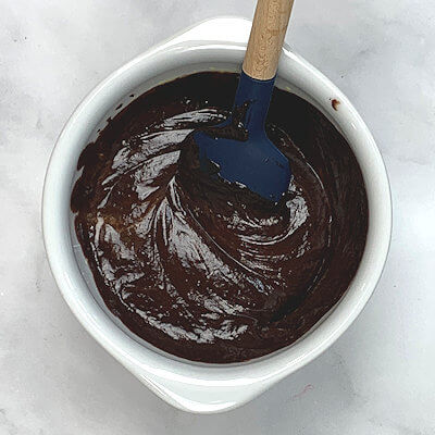 Step 3 - Add the slightly cooled chocolate to the egg yolk-sugar mixture and combine.