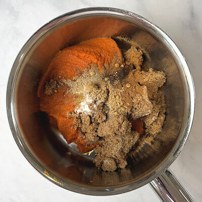 Step 2 - In a saucepan, combine pumpkin puree, sugar, salt and spices. Heat and stir until it bubbles. Allow it to simmer for a few minutes. Remove from heat.