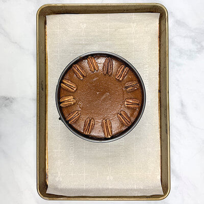 Step 6 - When the pie is done (still a little jiggly in the center, decorate with pecan halves.Transfer the pie to a wire rack and allow to cool.