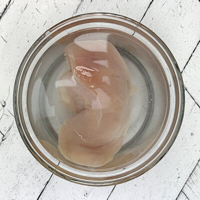 Step 1 - Brine your chicken breast, by submerging the meat in a quart of warm water with 1/4 cup of kosher salt.