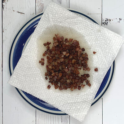 Step 2 - Cut the pancetta in small cubes and cook until crispy in a skillet. Once browned, drain on paper kitchen towel and discard grease.