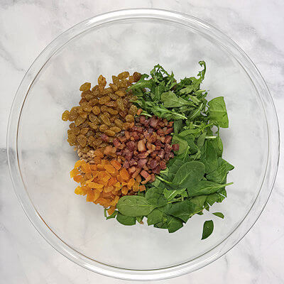 Step 4 - In a bowl mix all the ingredients: farro, spinach, arugula, raisins, apricots and pancetta.Add the dressing and toss to coat.