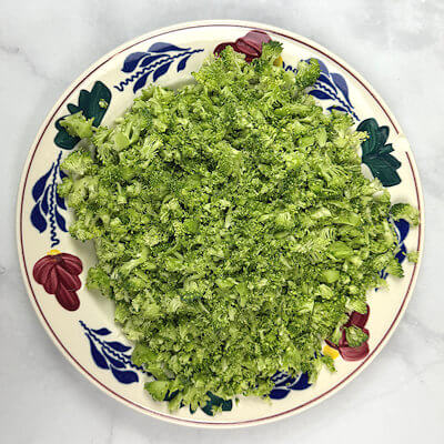 Step 2 - Chop the broccoli fine and cook the spinach until wilted and then chop a little bit as well.