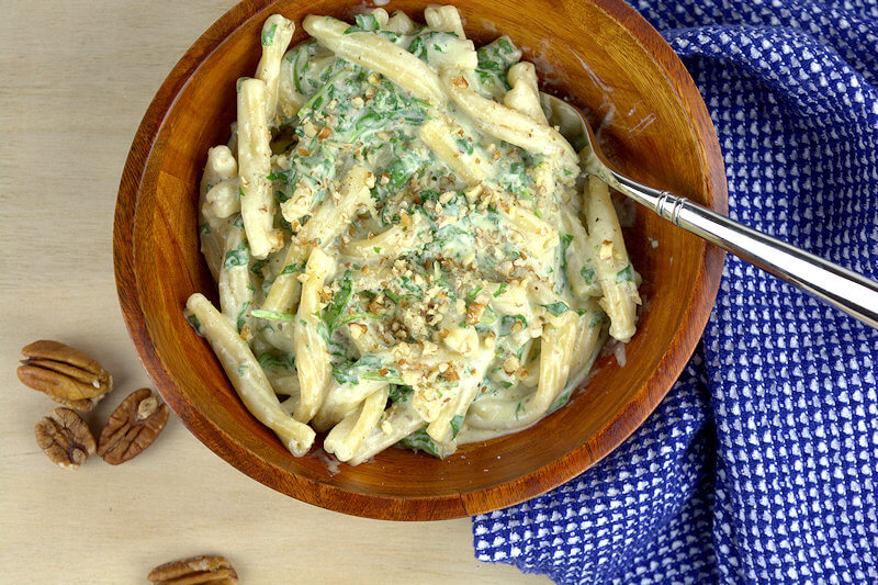 A top down look into a bowl of Casarecce with Arugula & Goat Cheese