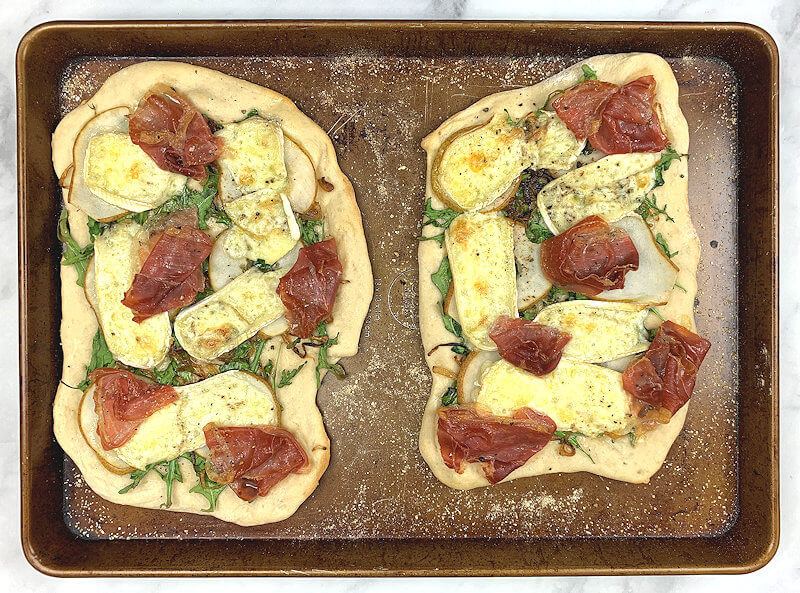 Two small Pear, Brie and Prosciutto pizzas, just out of the oven.