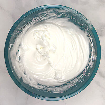 Step 2 - In a bowl, beat the egg whites on until it is frothy, about 20 seconds. With the mixer running, add the salt, then gradually add 30 grams of granulated sugar. Continue to beat until the whites hold soft peaks, for about 2 minutes.