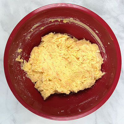 Step 4 - Add egg yolks, beating until incorporated. Add the ricotta, vanilla, orange zest and finely grated carrots, and beat on medium-low until incorporated; the mixture will not be smooth. Finish by folding by hand with a spatula, making sure the mixture is well combined.