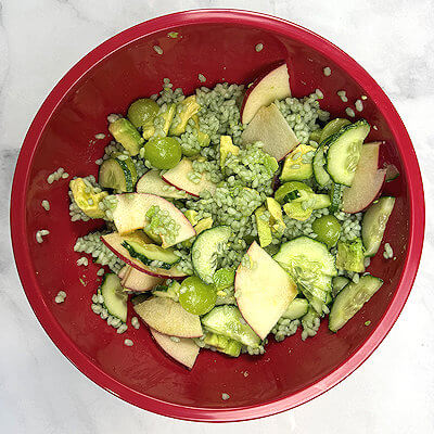Step 3 - Wash the cucumber (leave the skin on). Cut in half lengthwise and then cut half moon slices. Wash the grapes and cut in half. Dice the avocado. Cut the apple (leave the skin on) in slices. Once the rice is cooled, mix it with the slices vegetables and fruit.