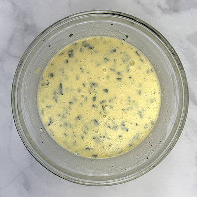 Step 3 - Combine milk, creme fraiche, grated Gruyere cheese, eggs in a bowl and mix. Add pepper and nutmeg to taste. Be sparse with the salt, as pancetta is a salty bacon. Add chopped parsley and mix.
