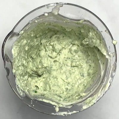 Step 3 - Make the Creamy Basil Blue Cheese Sauce by processing basil, blue cheese, ricotta, yogurt, sherry vinegar, garlic, and pepper in a food processor